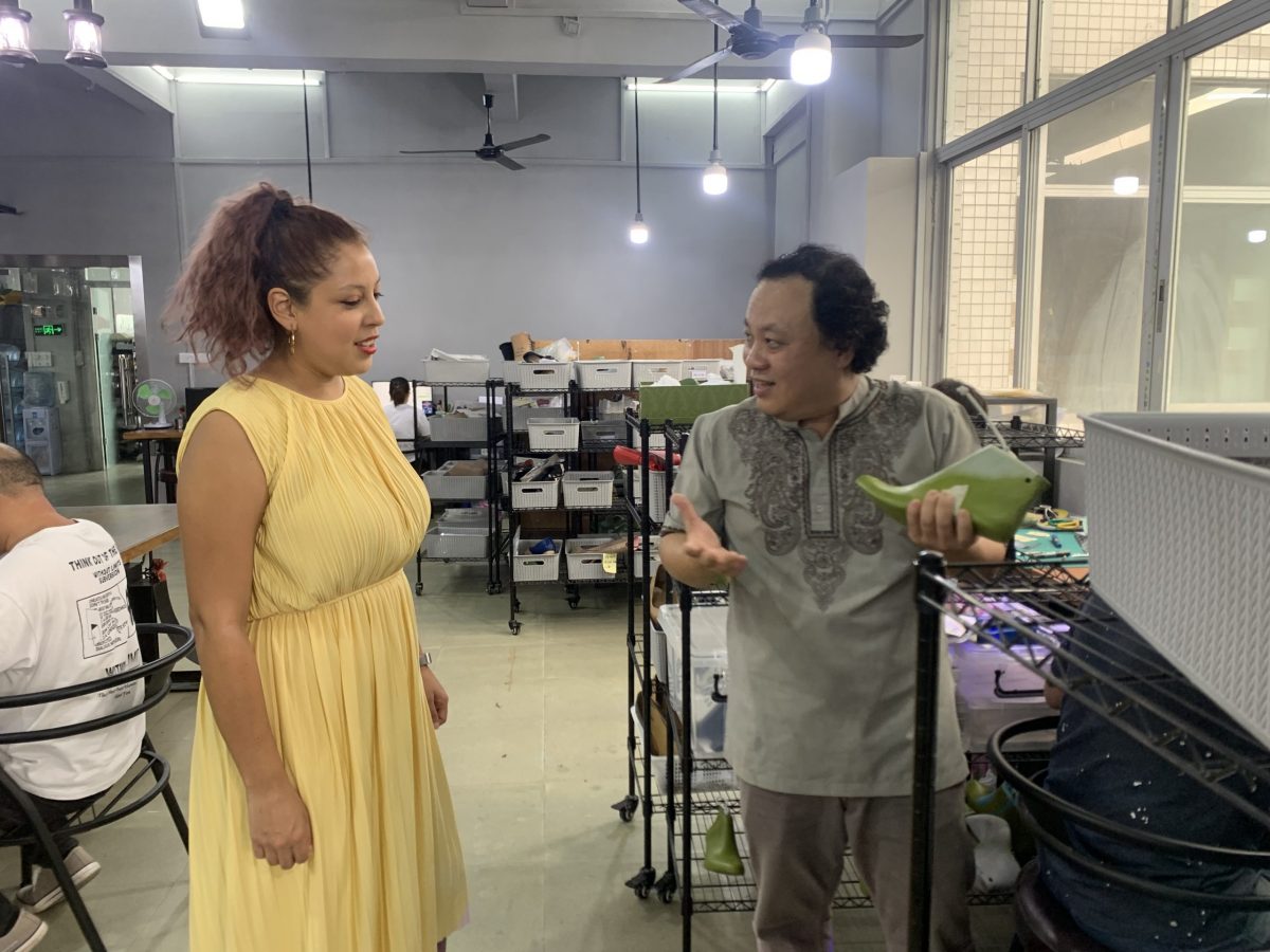 Dr SHOOZ showing a customer a pair of custom shoes in Guangzhou, China